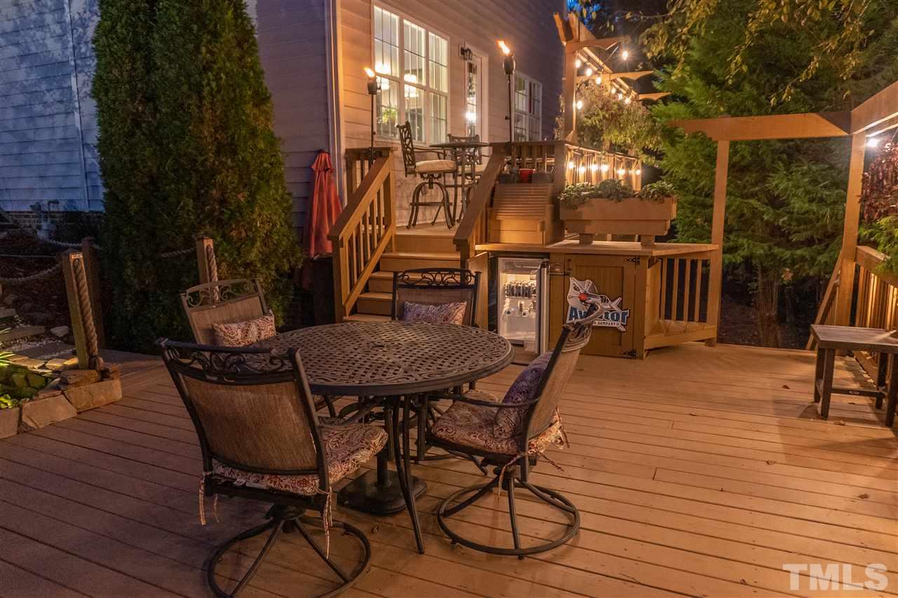 106 Braid Court Raleigh, NC 27603 - Photo 3 of 30 a view of a patio with table and chairs with wooden floor and fence