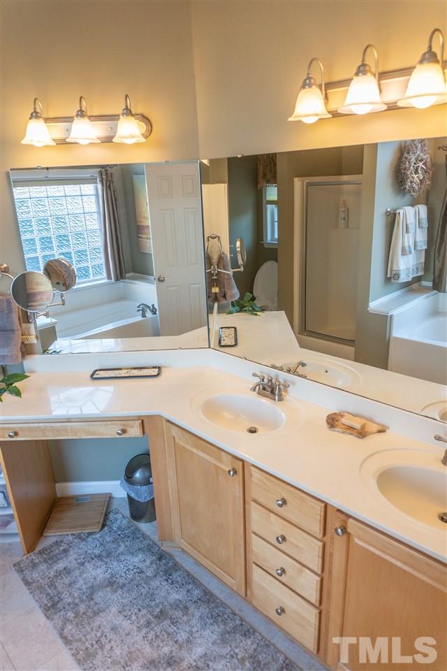 106 Braid Court Raleigh, NC 27603 - Photo 22 of 30 a bathroom with a sink and a mirror