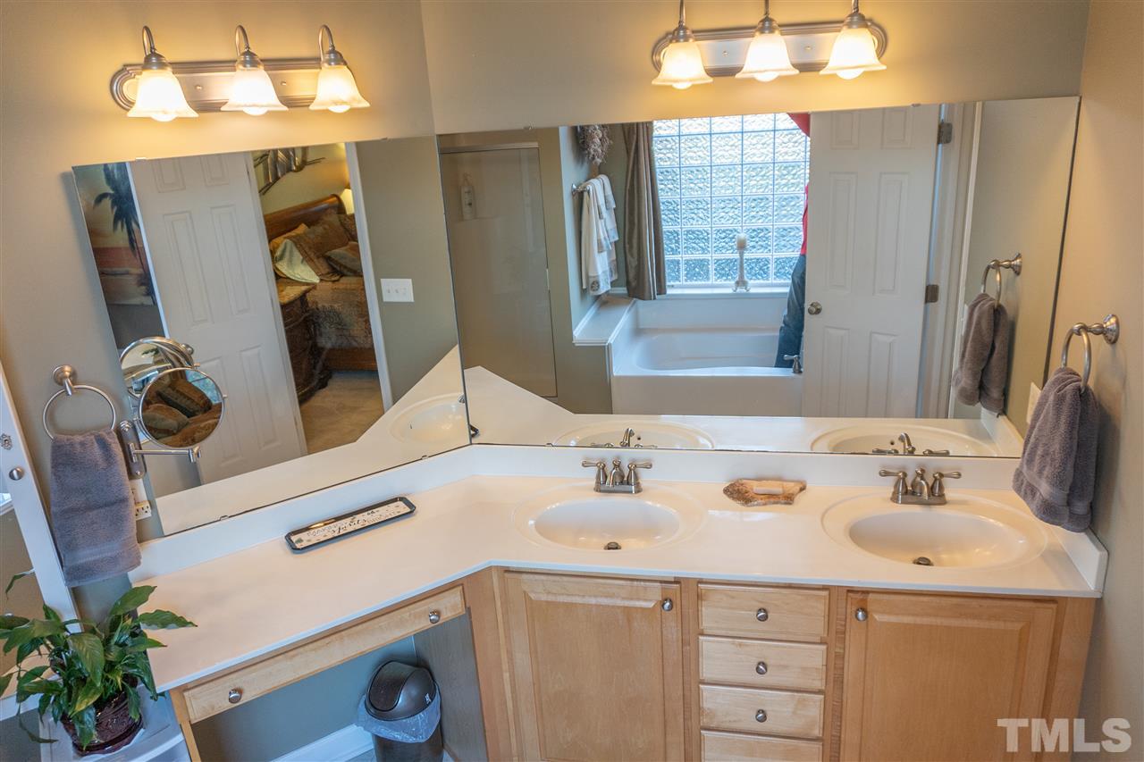 106 Braid Court Raleigh, NC 27603 - Photo 23 of 30 a bathroom with a sink and a mirror