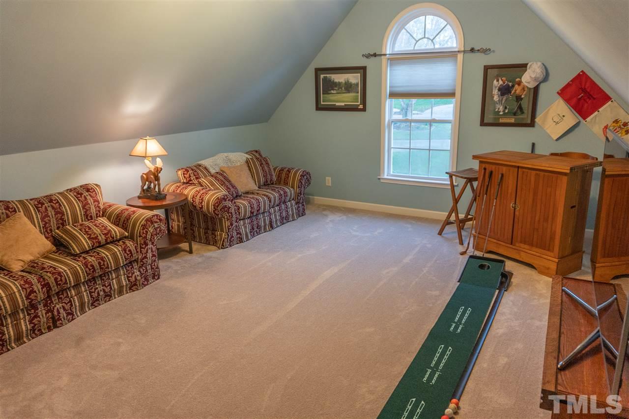 106 Braid Court Raleigh, NC 27603 - Photo 24 of 30 a living room with furniture a window and wooden floor