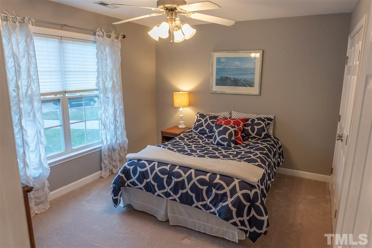 106 Braid Court Raleigh, NC 27603 - Photo 27 of 30 a bedroom with a bed and a window