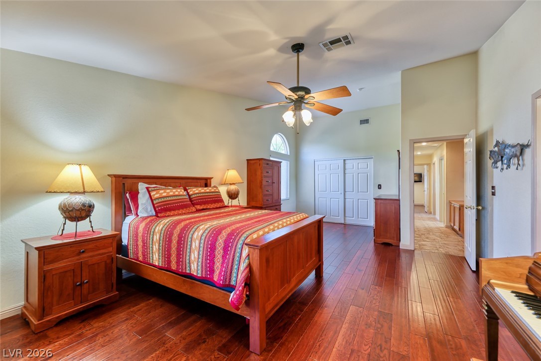 2001 Appaloosa Road Henderson, NV 89002 - Photo 32 of 44 This spacious bedroom features lustrous hardwood flooring, offering a warm and inviting retreat.