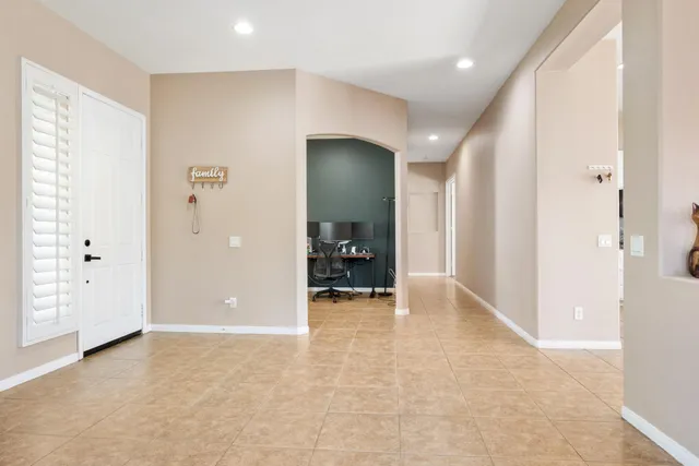 a view of a hallway with wooden floor and closet