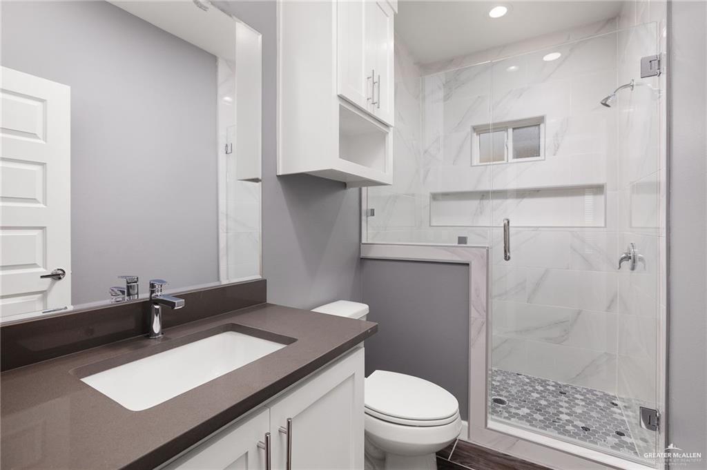 1801 Monaco Drive, Unit 2 San Juan, TX 78589 - Photo 11 of 17 a bathroom with a sink a toilet and shower