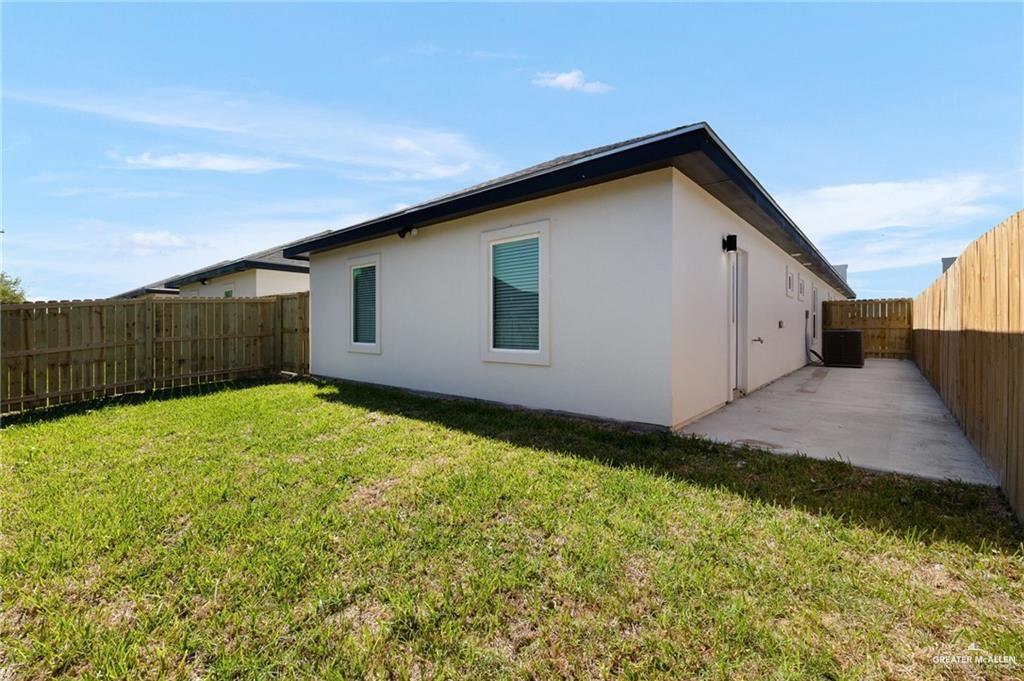 1801 Monaco Drive, Unit 2 San Juan, TX 78589 - Photo 14 of 17 a view of backyard of house with wooden fence