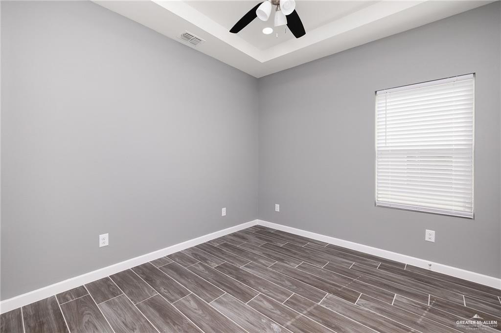1801 Monaco Drive, Unit 2 San Juan, TX 78589 - Photo 10 of 17 an empty room with a window and ceiling fan
