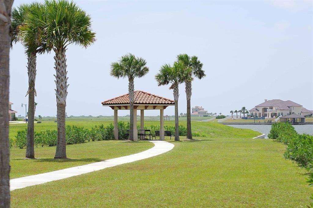0 West Lago Loop Road Port O'Connor, TX 77982 - Photo 7 of 15 a view of a swimming pool with a yard and palm trees