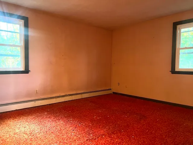 an empty room with windows and closet