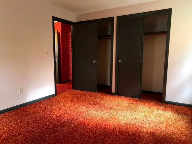 a bathroom with a toilet and a shower curtain