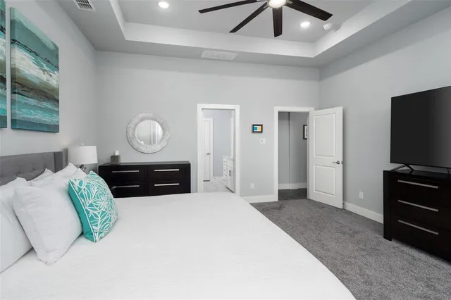 a bedroom with a bed and a television