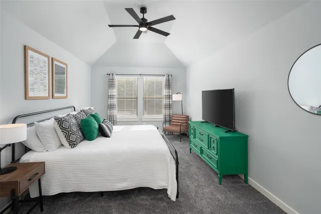 a bathroom with a bathtub shower sink vanity mirror and toilet