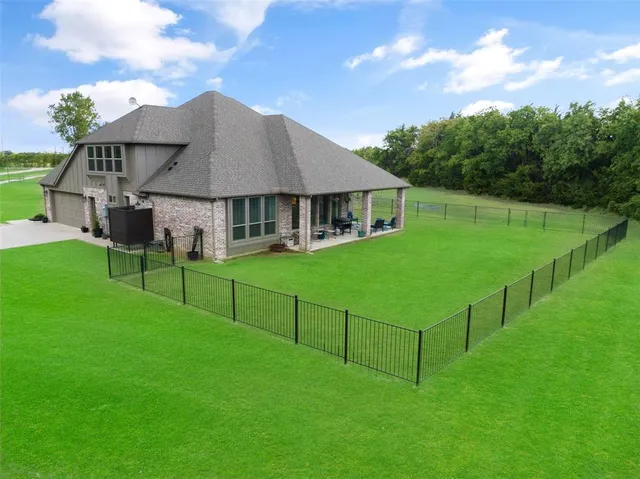 a view of a big yard with large trees and plants