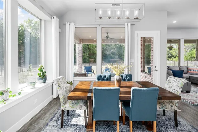a view of a dining room with furniture a livingroom and chandelier