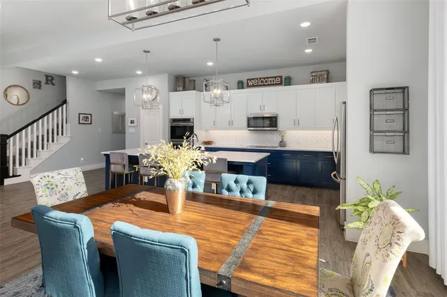 a dining room with furniture and a chandelier