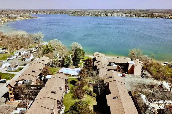 an aerial view of a house with a lake view