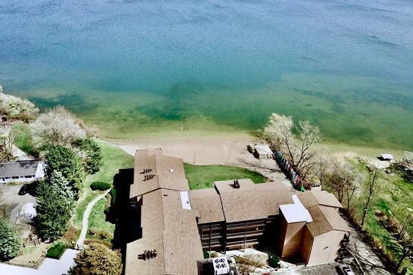 an aerial view of a house with a yard