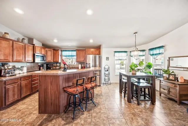 a kitchen with lots of wooden furniture appliances and furniture