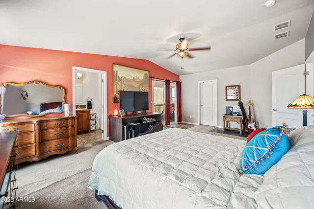 a bedroom with furniture and a flat screen tv