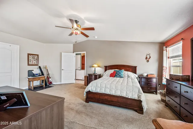 a bedroom with a bed and a tv on the dresser