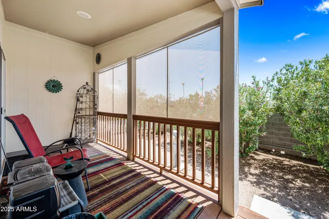 a living room with a floor to ceiling window and wooden floor