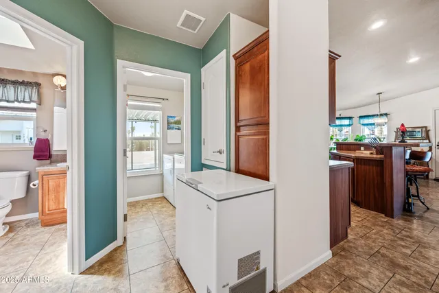 a bathroom with a granite countertop toilet sink and mirror