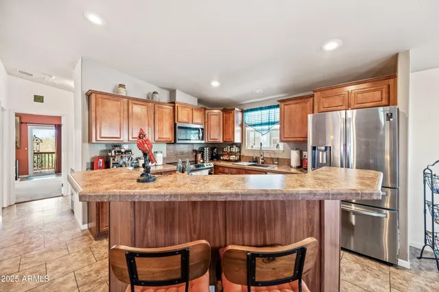 a large kitchen with kitchen island granite countertop a sink and cabinets