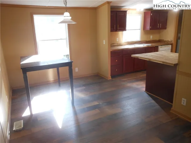 a kitchen with stainless steel appliances granite countertop a sink window and a refrigerator