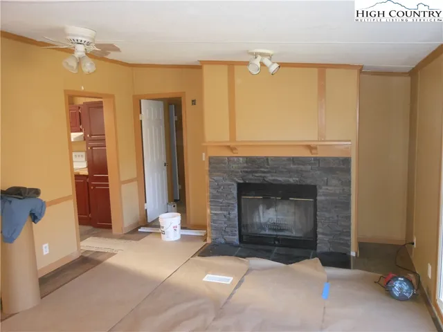 a living room with a fireplace windows and a fireplace