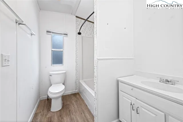 a bathroom with a toilet a sink and shower