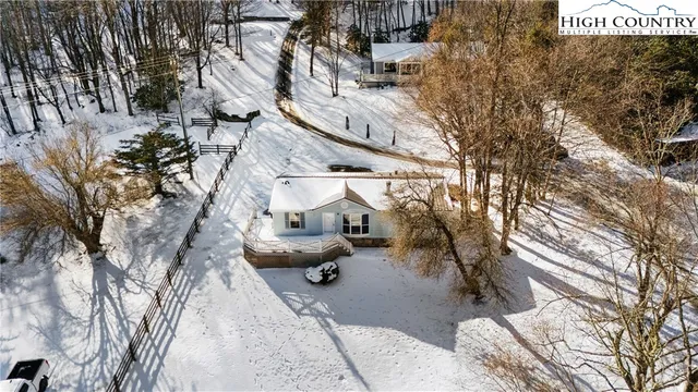 a view of a house with wooden deck and living room