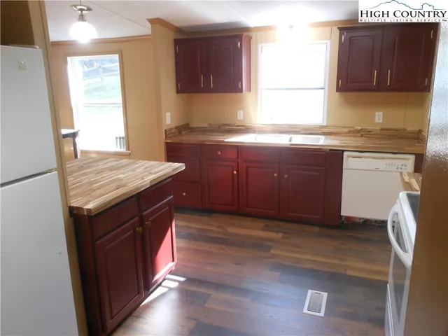 a kitchen with stainless steel appliances granite countertop a sink stove and cabinets