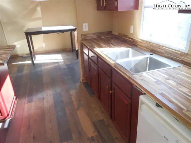a kitchen with a sink and a stove top oven