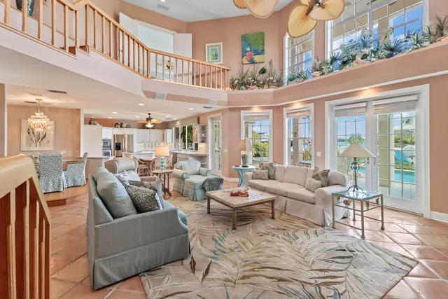 a dining room filled chandelier and kitchen view
