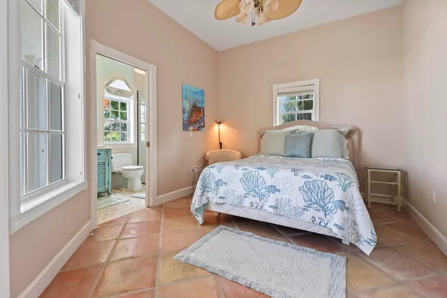 a bedroom with two beds and a window