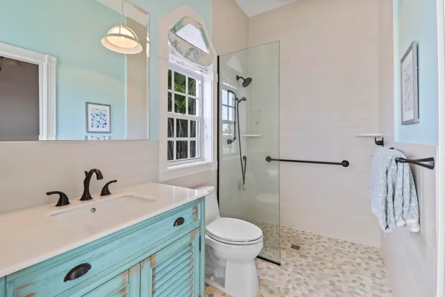 a bathroom with a sink toilet and a mirror
