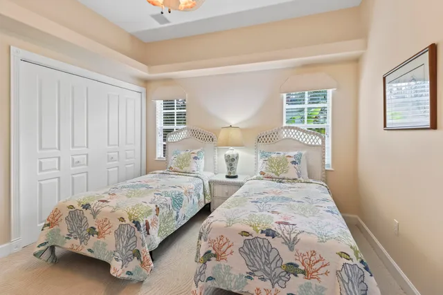 a bedroom with bed a flat tv screen and dresser