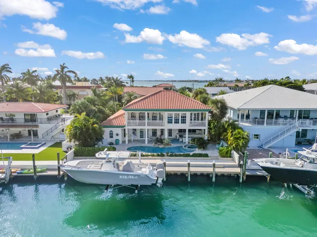 a view of a house with swimming pool and sitting area