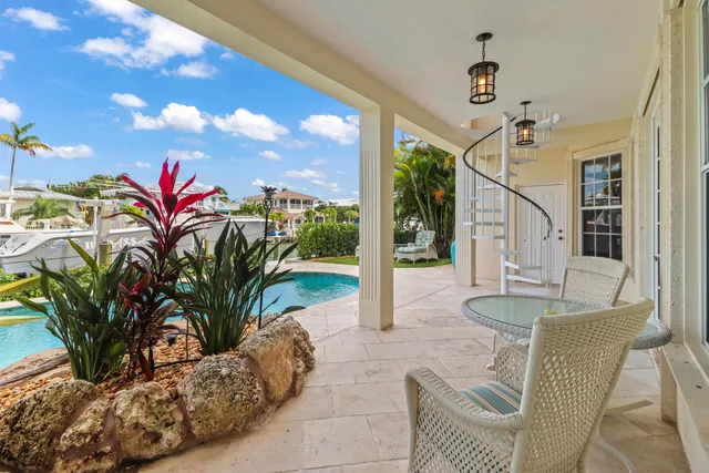 a front view of a house with porch and garden