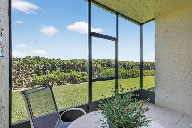 a view of a grassy field and an trees