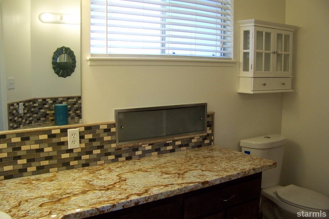 165 Pinion Road Markleeville, CA 96120 - Photo 24 of 34 a bathroom with a granite countertop sink and a toilet