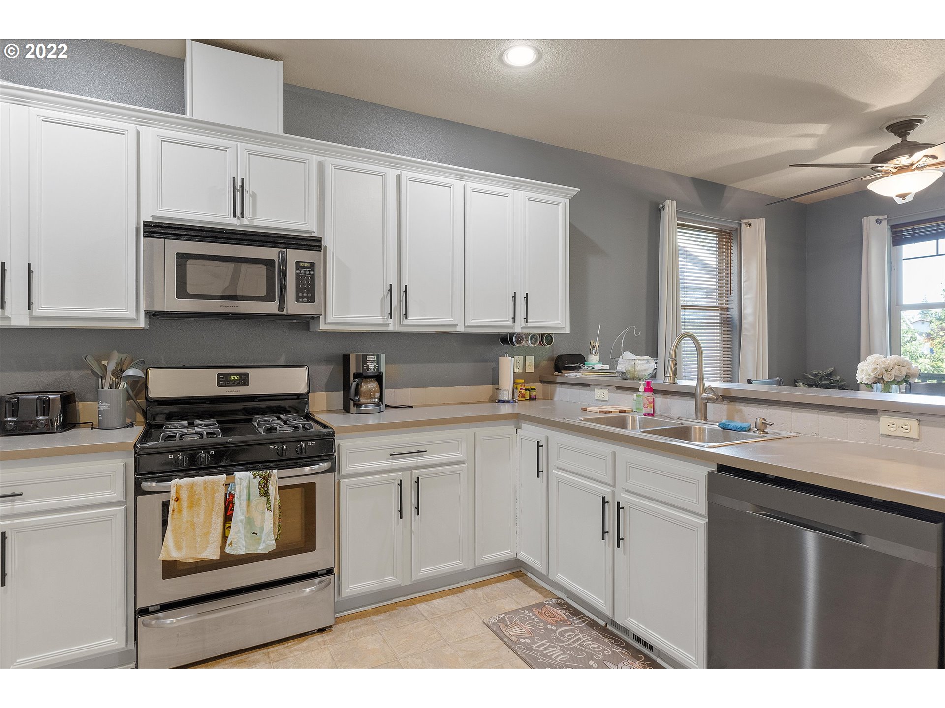 40310 Dubarko Road Sandy, OR 97055 - Photo 4 of 23 a kitchen with stainless steel appliances granite countertop a stove sink and cabinets