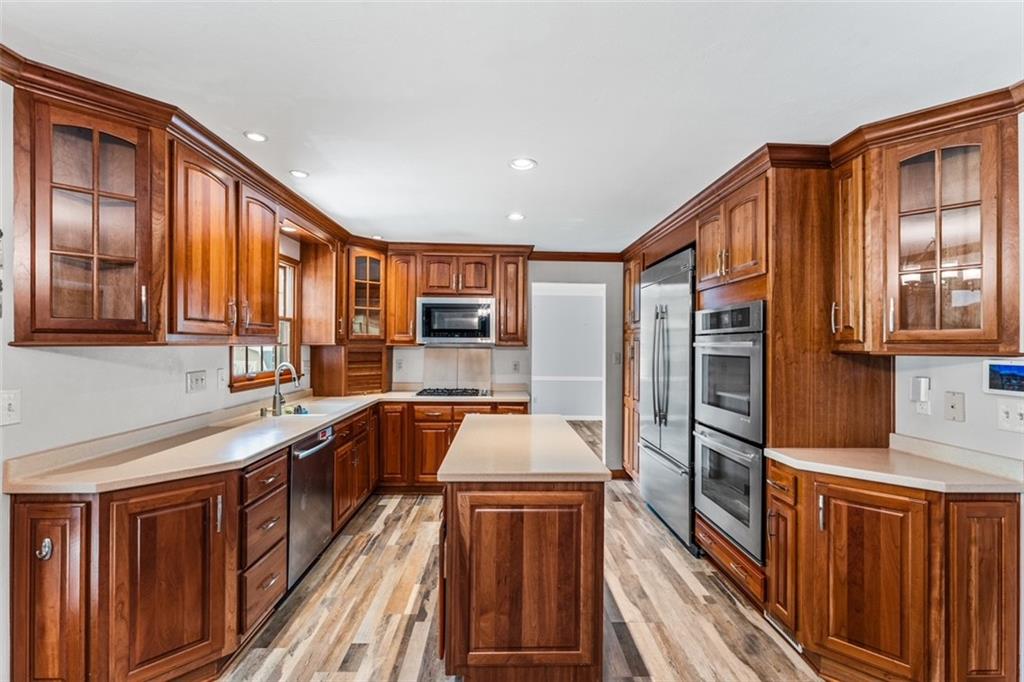 120 Timothy Road Gibsonia, PA 15044 - Photo 11 of 50 a kitchen with stainless steel appliances granite countertop a refrigerator a stove and wooden cabinets
