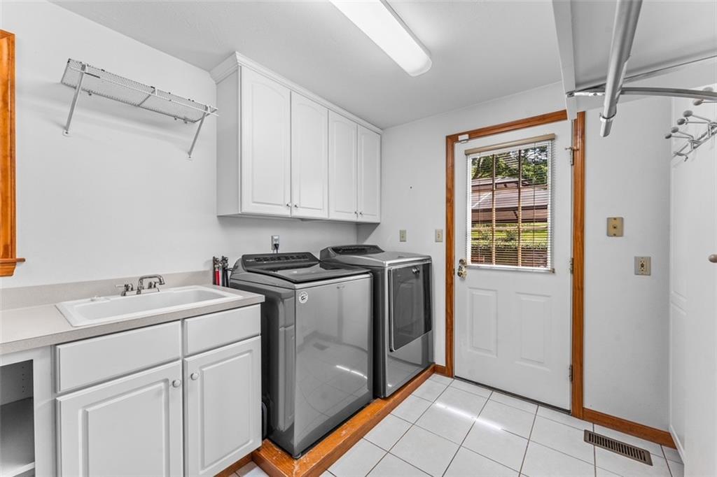 120 Timothy Road Gibsonia, PA 15044 - Photo 22 of 50 a utility room with cabinets washer and dryer