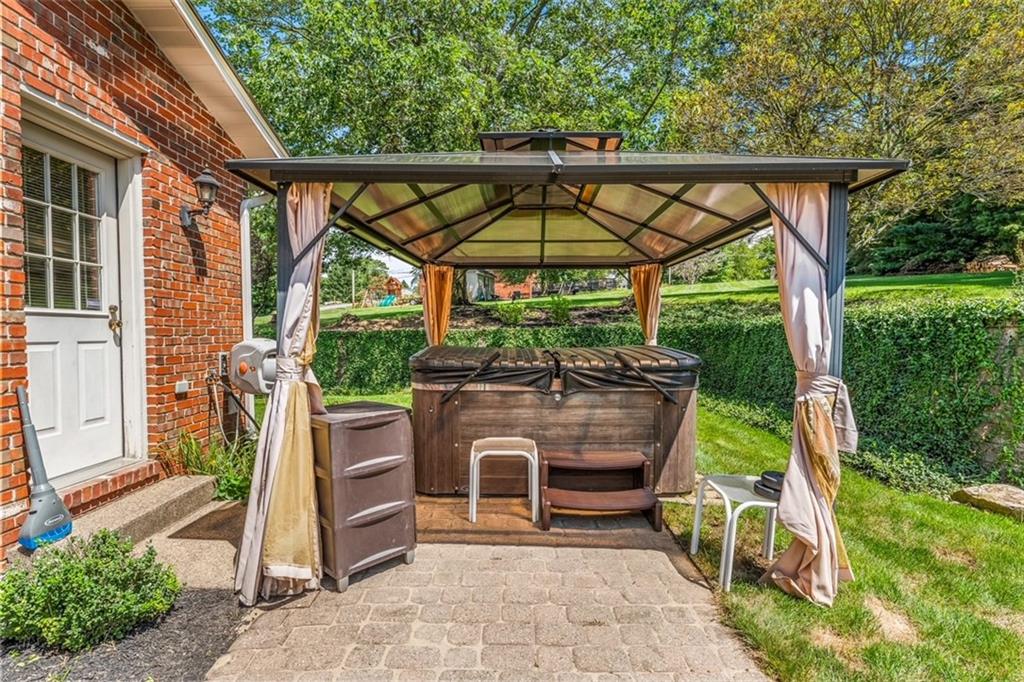 120 Timothy Road Gibsonia, PA 15044 - Photo 43 of 50 a view of a patio with table and chairs under an umbrella with a small yard