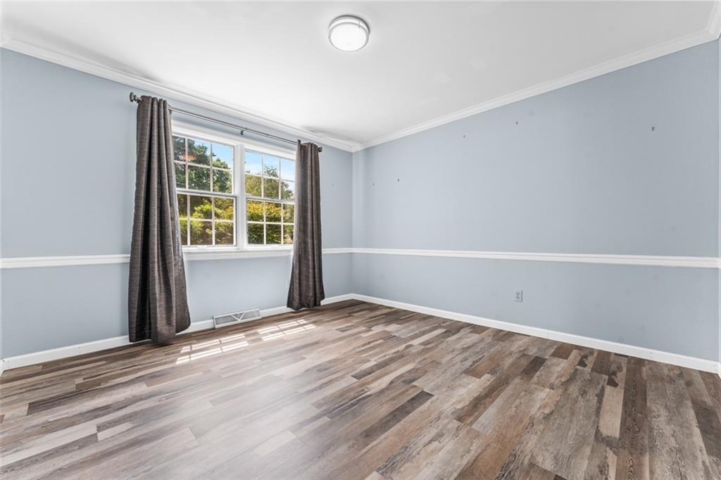 120 Timothy Road Gibsonia, PA 15044 - Photo 5 of 50 a view of an empty room with wooden floor and a window