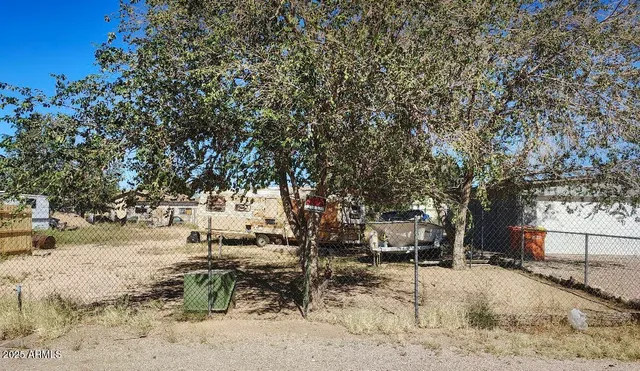 a view of a yard with snow on the road
