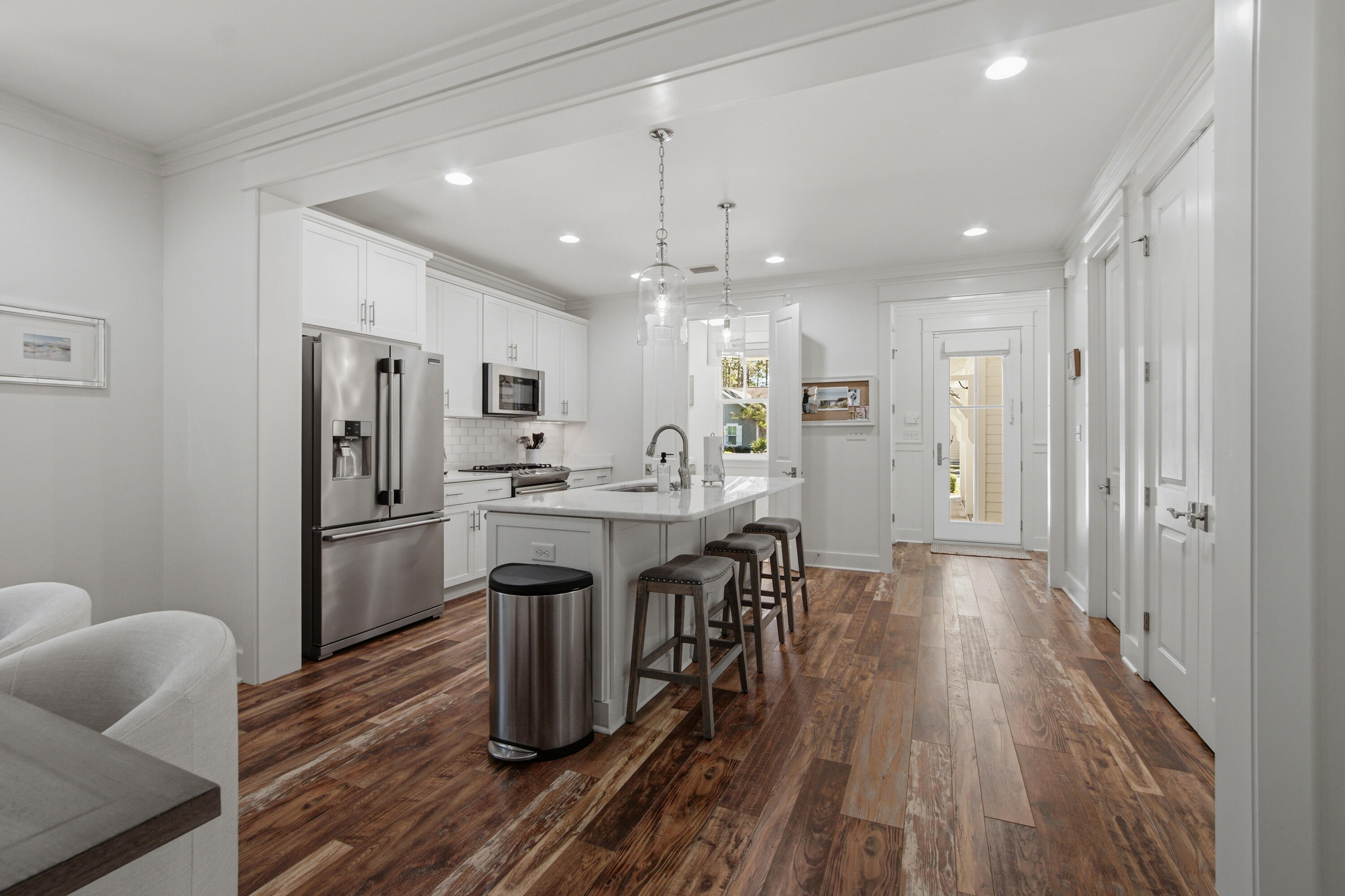 755 Breakers Street, Unit LOT 50 Inlet Beach, FL 32461 - Photo 12 of 61 a kitchen with kitchen island wooden floors white appliances and cabinets