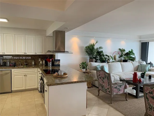 a kitchen with a white cabinets and chair