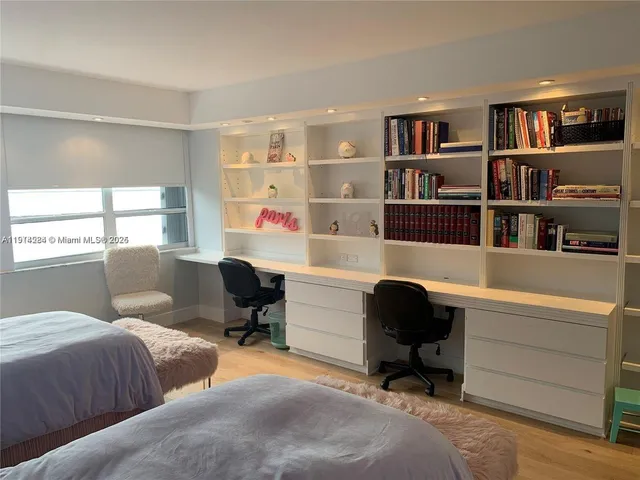 a workspace with a couch and a bookshelf