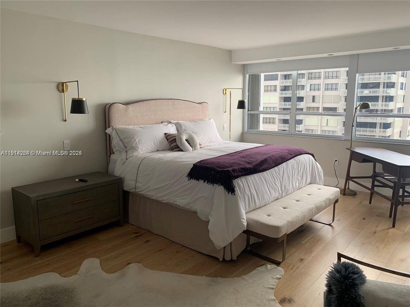 2 Grove Isle Drive, Unit B1507 Miami, FL 33133 - Photo 6 of 13 a bedroom with a bed couch and a large window